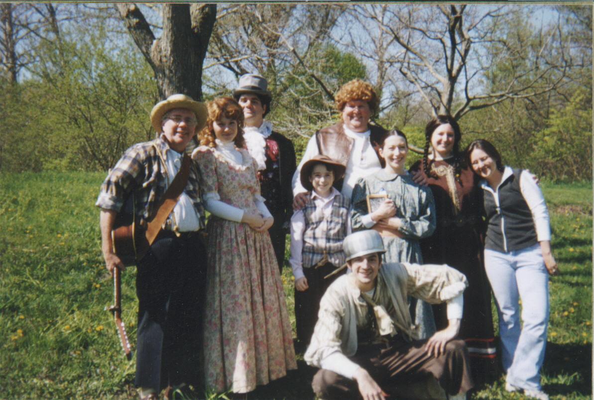 Nine actors dressed for a production of Johnny Appleseed